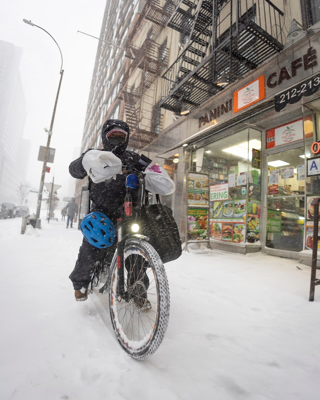 A food delivery courier riding through the city