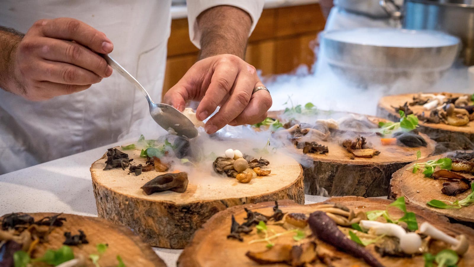 A chef plating dinner during service, the work the commission line silently scales against