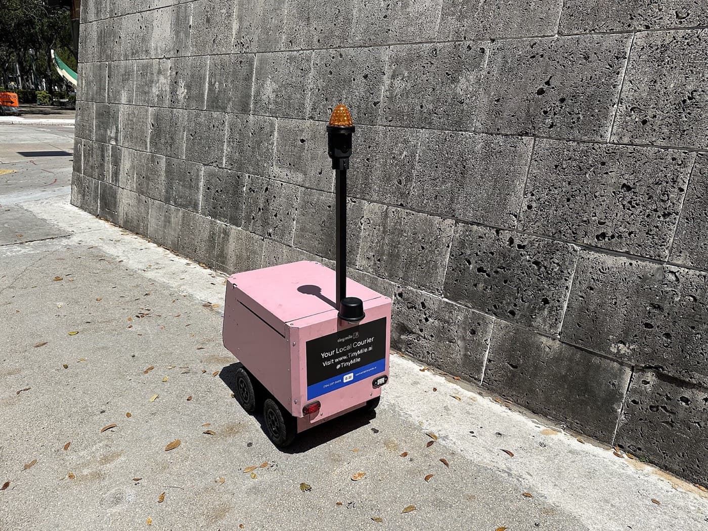 A sidewalk delivery robot on its route