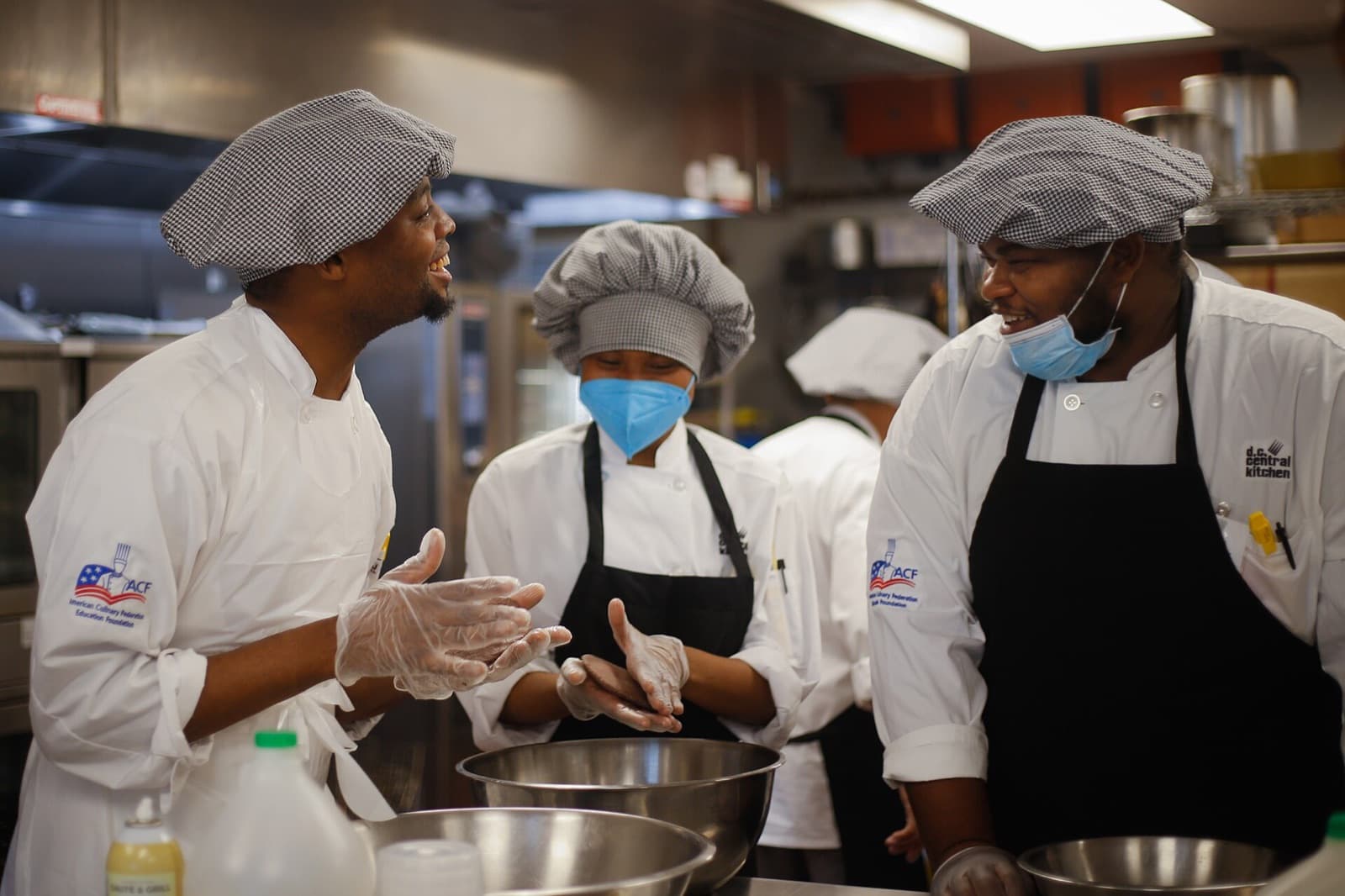 A kitchen huddle: the handoff works when the next person can act without recreating the conversation