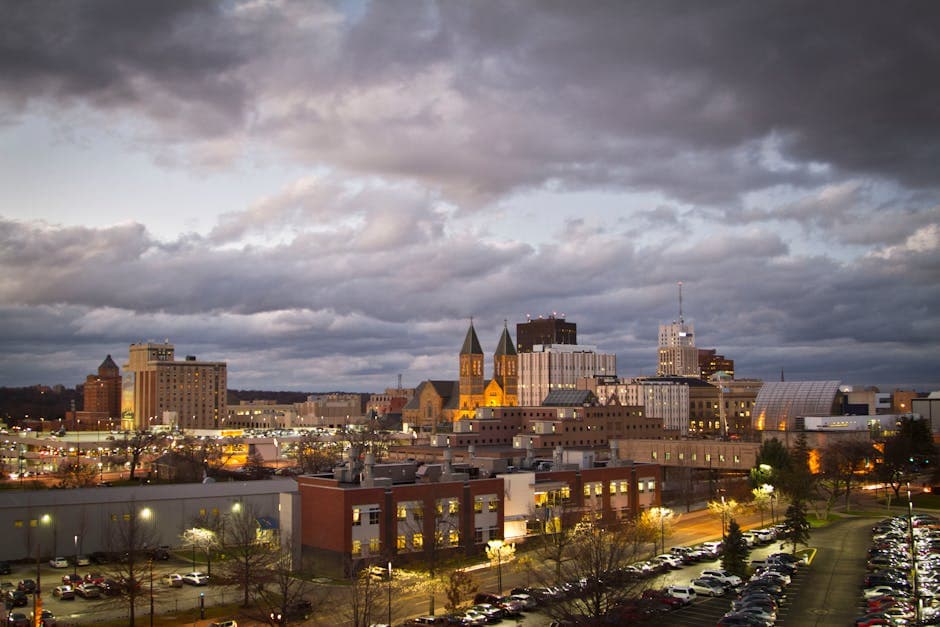 Akron, Ohio skyline with the downtown Main Street corridor, the Akron Civic Theatre marquee, and the Goodyear blimp hangar in the distance