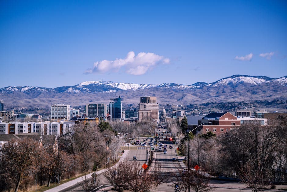 Downtown Boise at dusk with the Idaho Statehouse dome and the Boise Foothills in the distance