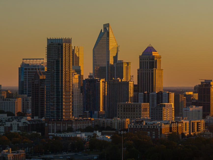 Uptown Charlotte skyline at dusk with the Bank of America Corporate Center and the Duke Energy tower
