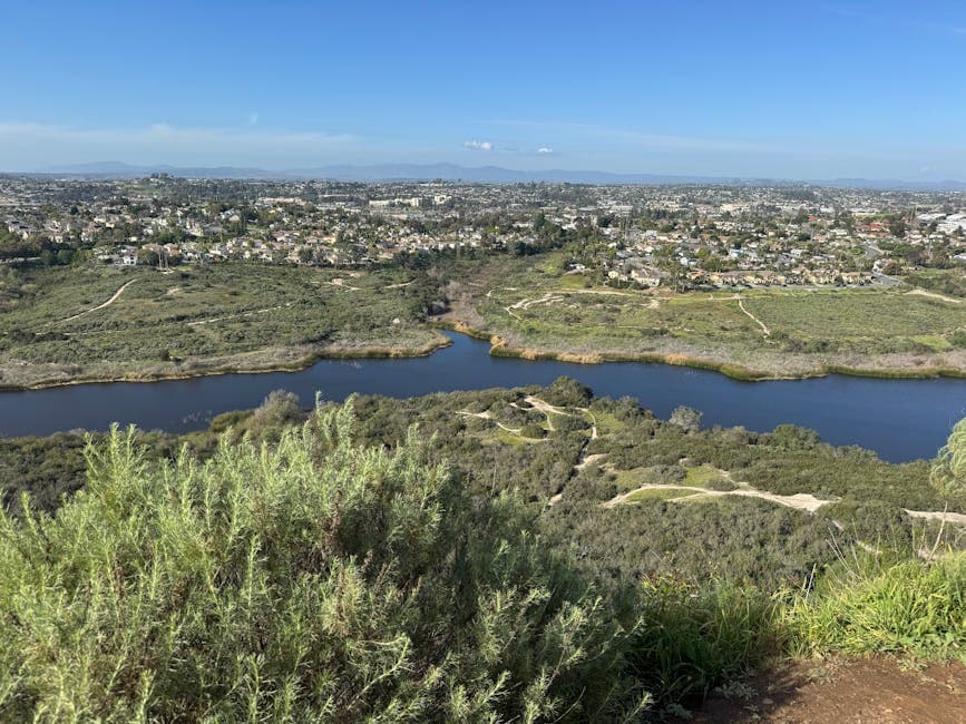 Chula Vista coastline at sunset, with the Sweetwater Channel and Bayfront waterfront in the foreground and the Coronado Bridge in the haze