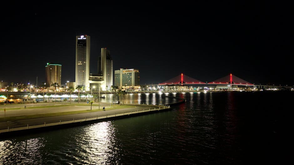 Corpus Christi Bayfront skyline with the Harbor Bridge, the USS Lexington across the bay, and the seawall on Shoreline Boulevard