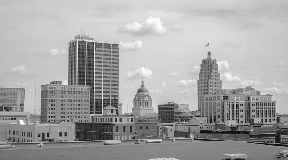 Fort Wayne, Indiana skyline at dusk along the riverfront, with Promenade Park and downtown towers