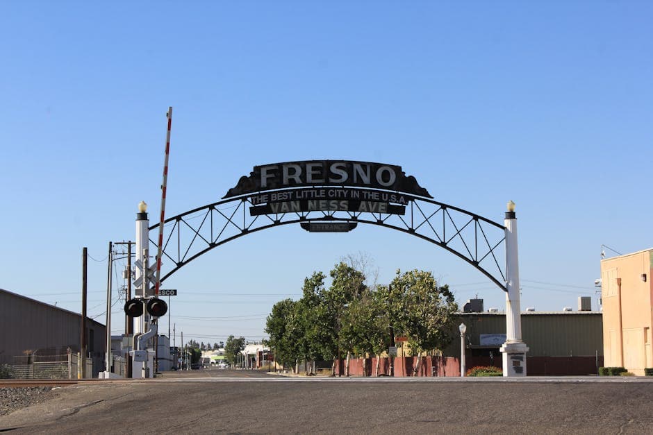 Fresno Tower District Art Deco theater marquee at dusk with the Sierra Nevada ridge behind it