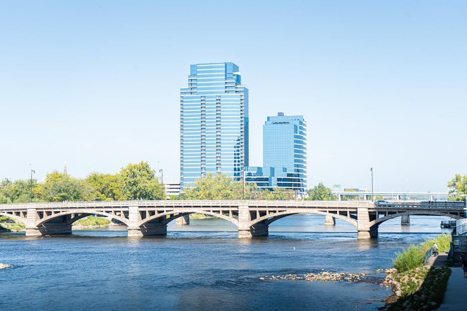 Grand Rapids skyline looking west across the Grand River, with the downtown towers and the Gerald R. Ford Presidential Museum visible in the frame.