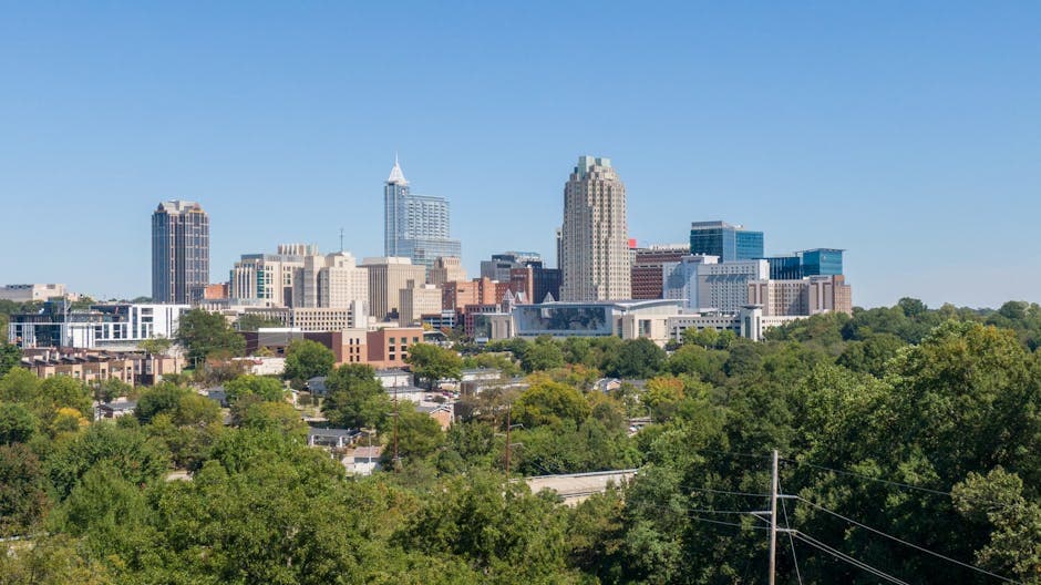 Center City Greensboro at dusk with the Elm Street corridor and the Lincoln Financial tower