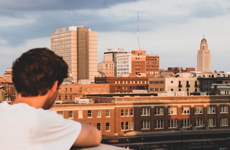 Lincoln, Nebraska skyline with the State Capitol tower rising over downtown and Memorial Stadium in the distance