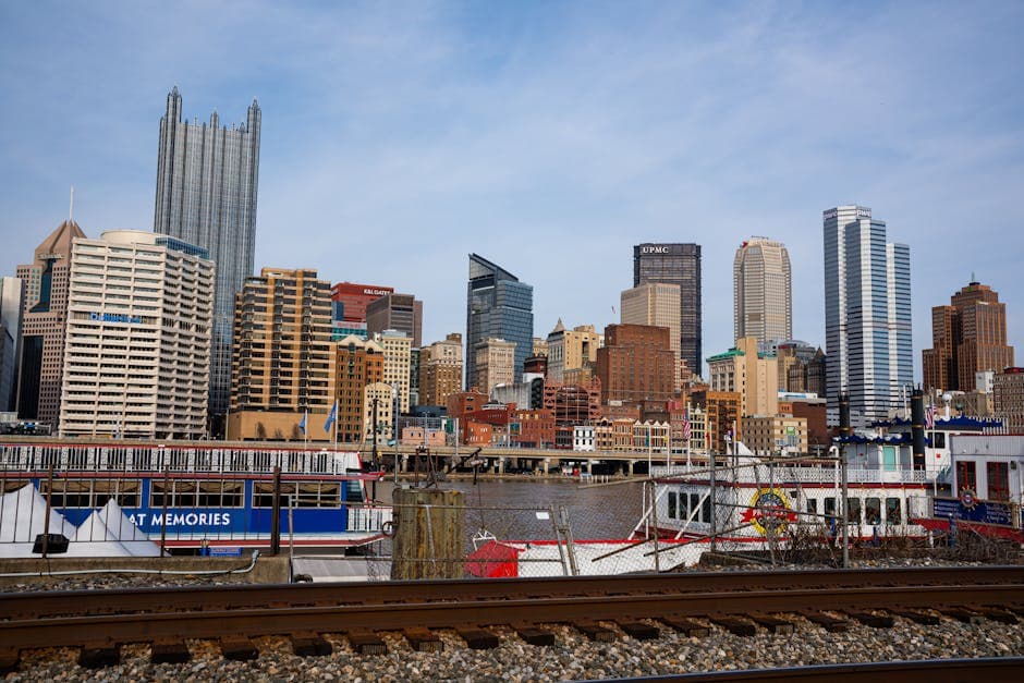 Pittsburgh downtown skyline at the confluence of the Allegheny and Monongahela rivers, with the Sixth Street Bridge and North Shore stadiums