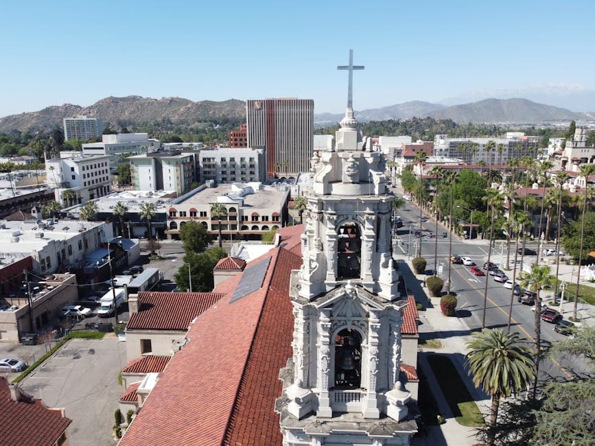 Mission Inn bell tower with citrus blossoms in the foreground