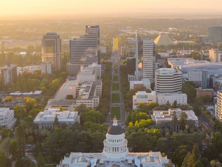 Sacramento Tower Bridge in gold, with the Sacramento River and Capitol skyline behind it at sunset