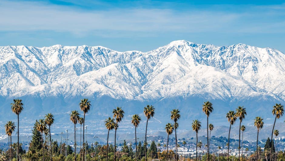 San Bernardino skyline with the San Bernardino Mountains behind and a Route 66 motel sign in the foreground
