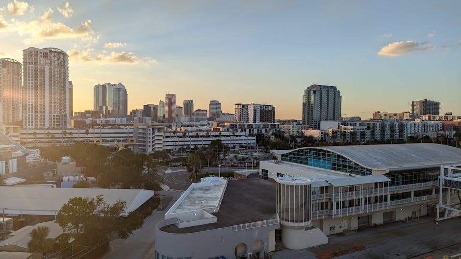 Tampa skyline at dusk, the Hillsborough River curving past downtown and Ybor City